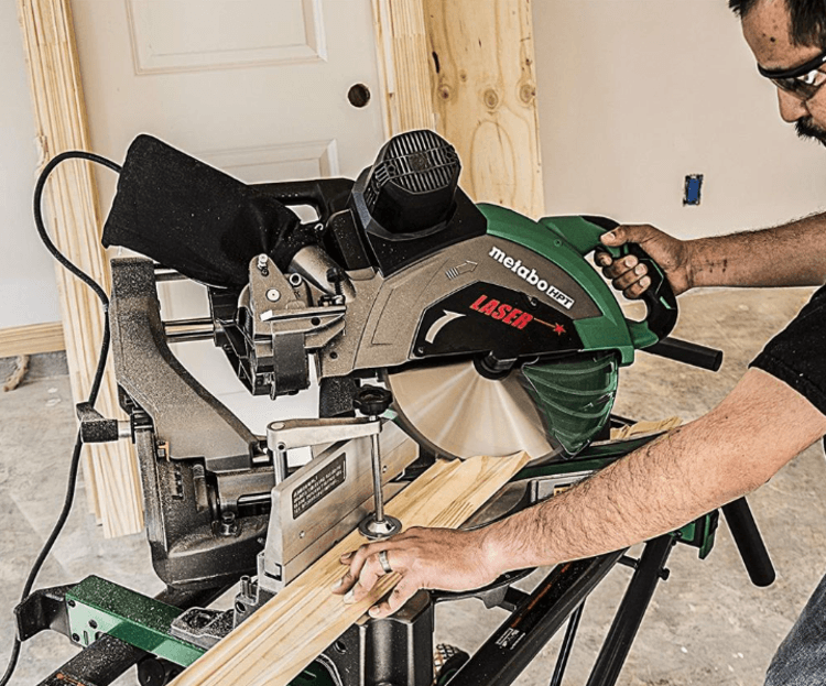 Cutting a wood panel with a miter saw